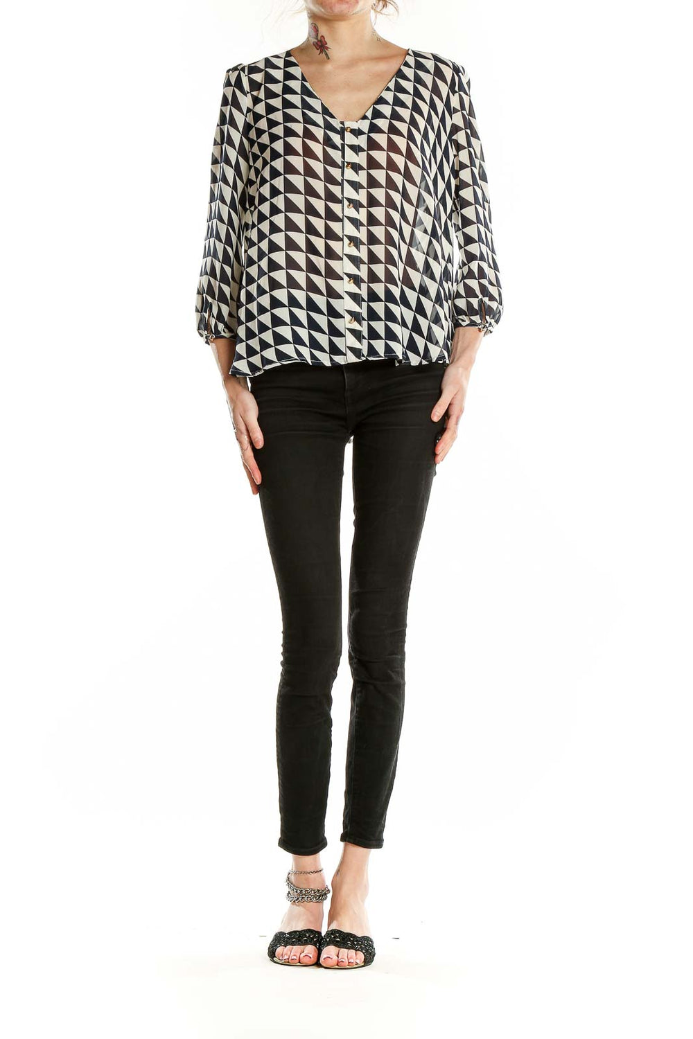 Front view of Lucy Paris black and white geometric print blouse with V-neck and button-front closure