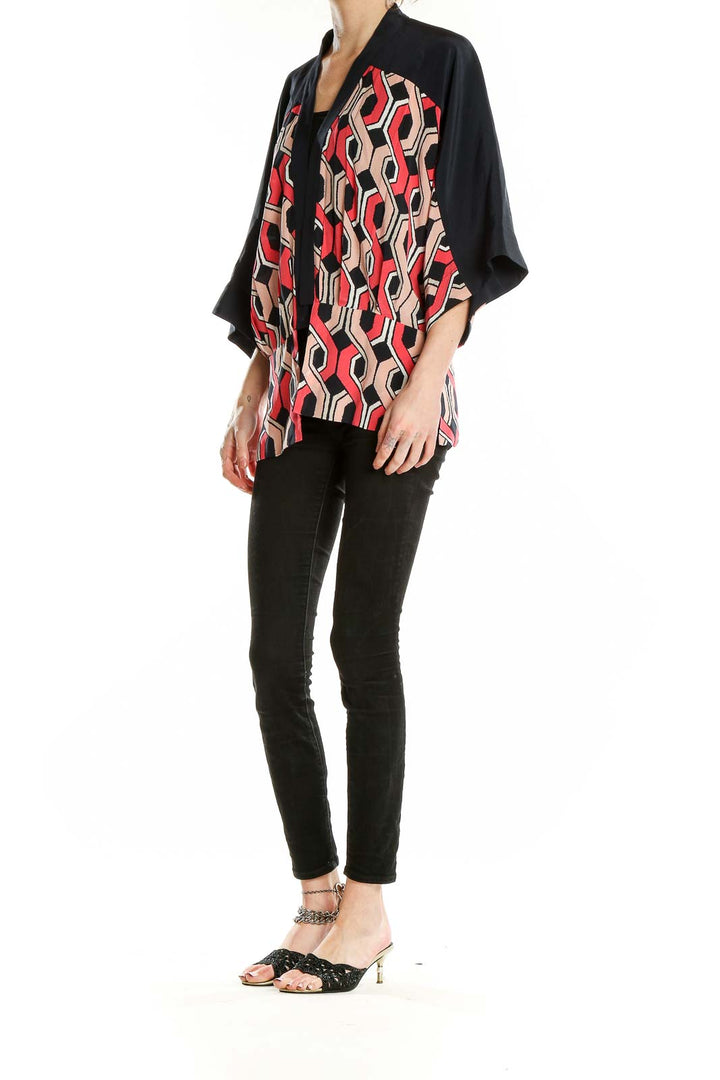 Front view of Trina Turk black, red, and beige geometric print silk kimono top