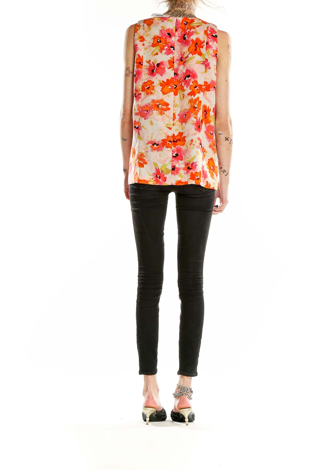 Back view of LOFT orange floral sleeveless blouse on model with black pants