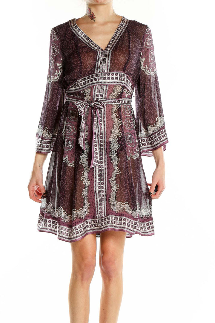 Front view of burgundy paisley print wrap dress with V-neckline and bell sleeves