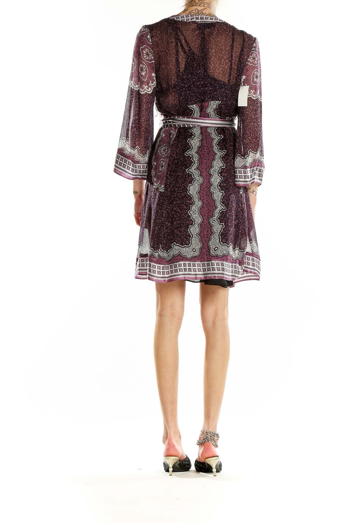 Back view of burgundy paisley print wrap dress showing flowy silhouette