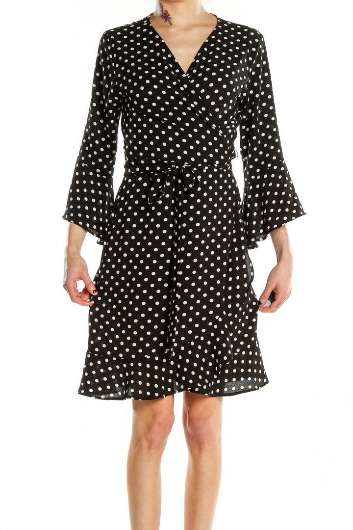 Front view of Veronicam black polka dot wrap dress with bell sleeves