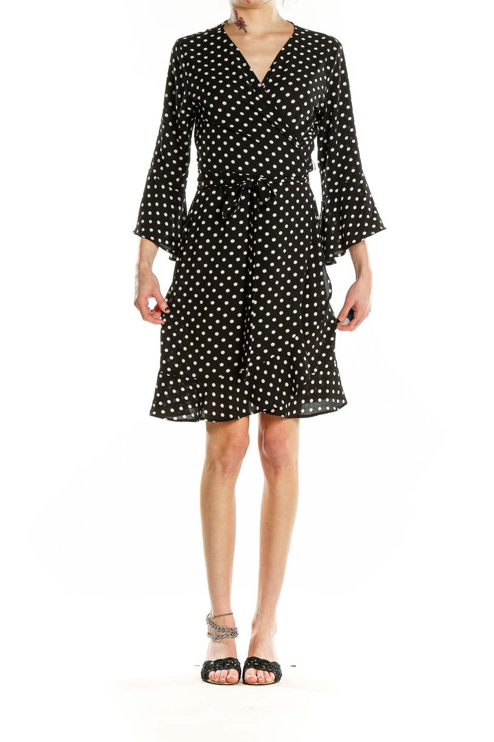 Front view of Veronicam black polka dot wrap dress with bell sleeves