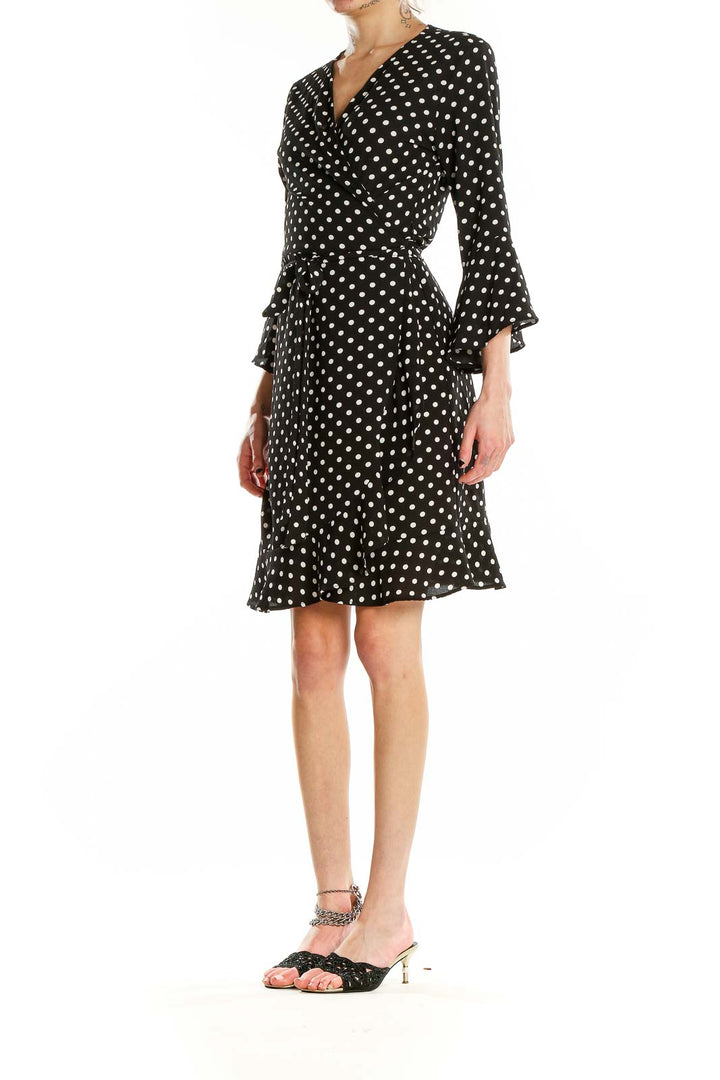 Front view of Veronicam black polka dot wrap dress with bell sleeves