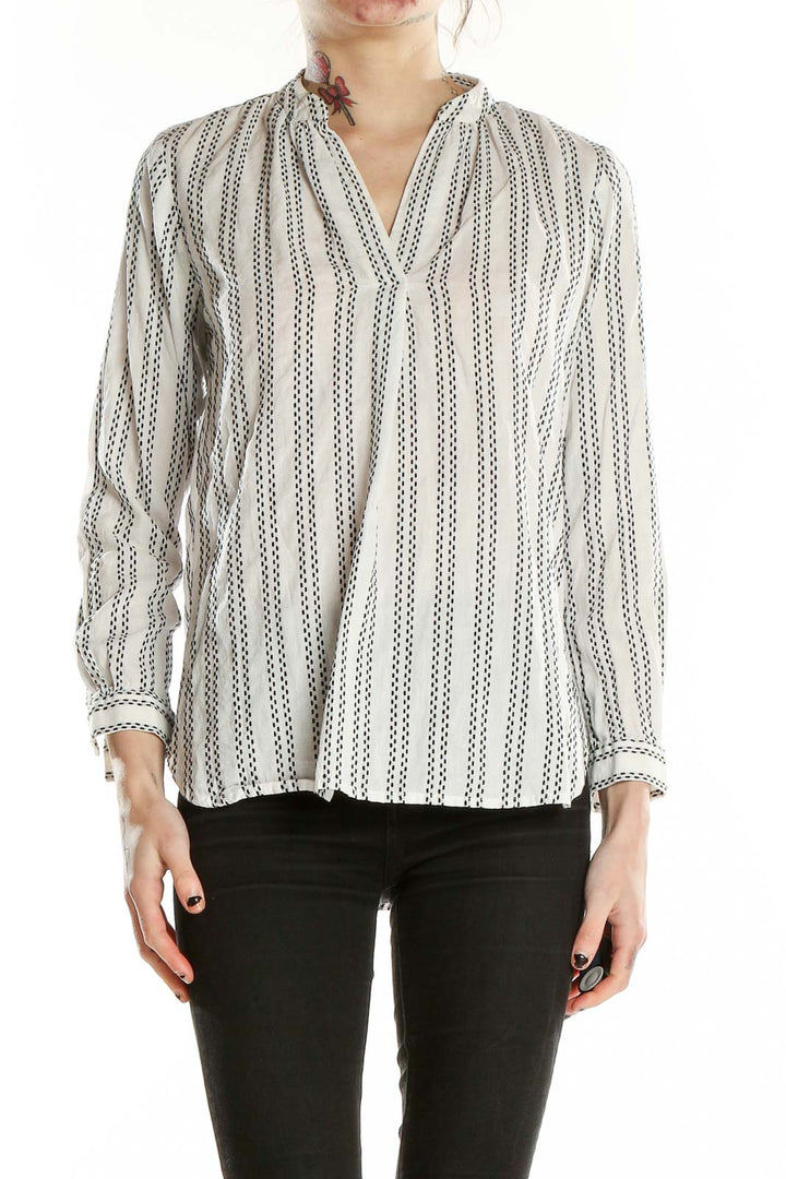 Front view of LOFT white striped V-neck blouse on model