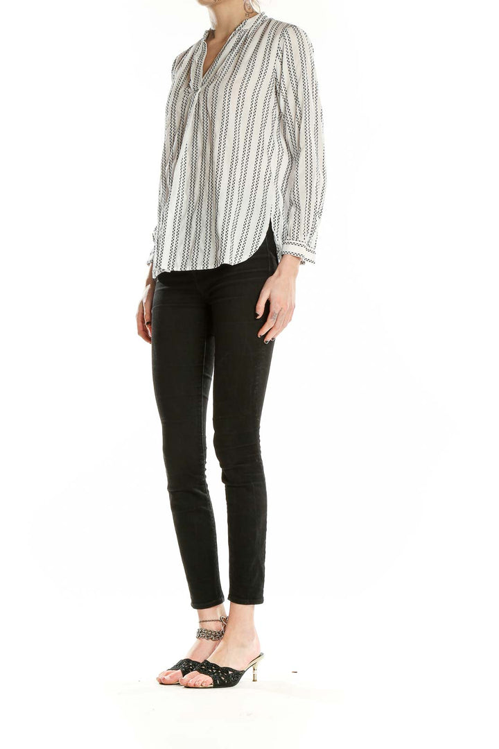 Front view of LOFT white striped V-neck blouse on model