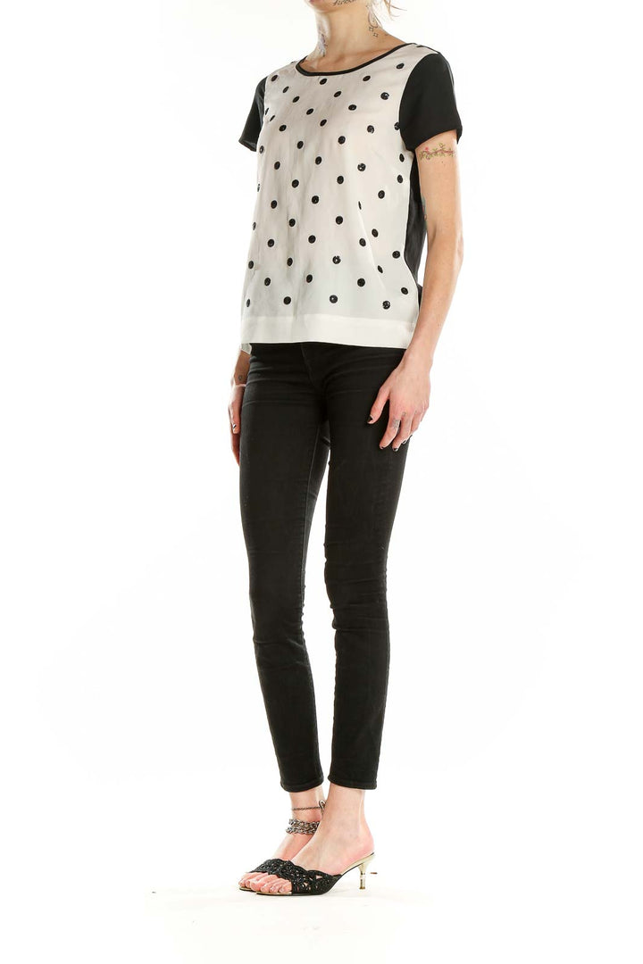 Front view of Coldwater Creek white top with black polka dots and contrasting black sleeves