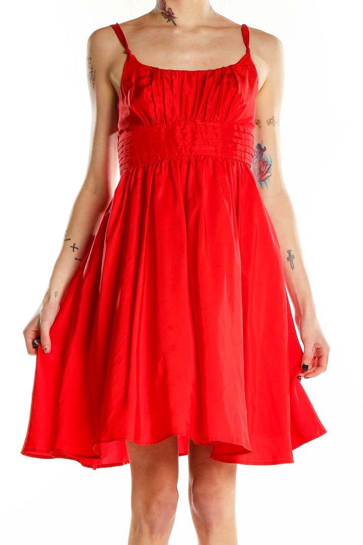 Front view of red silk flowy cocktail dress by Moulinette Soeurs