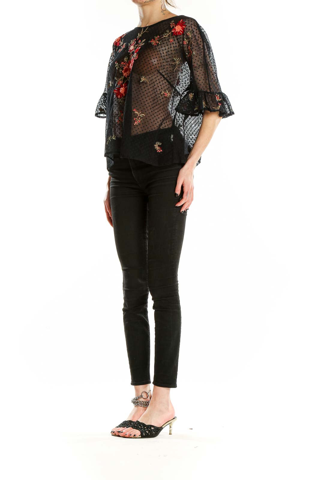 Front view of Maeve black sheer blouse with red floral embroidery and bell sleeves