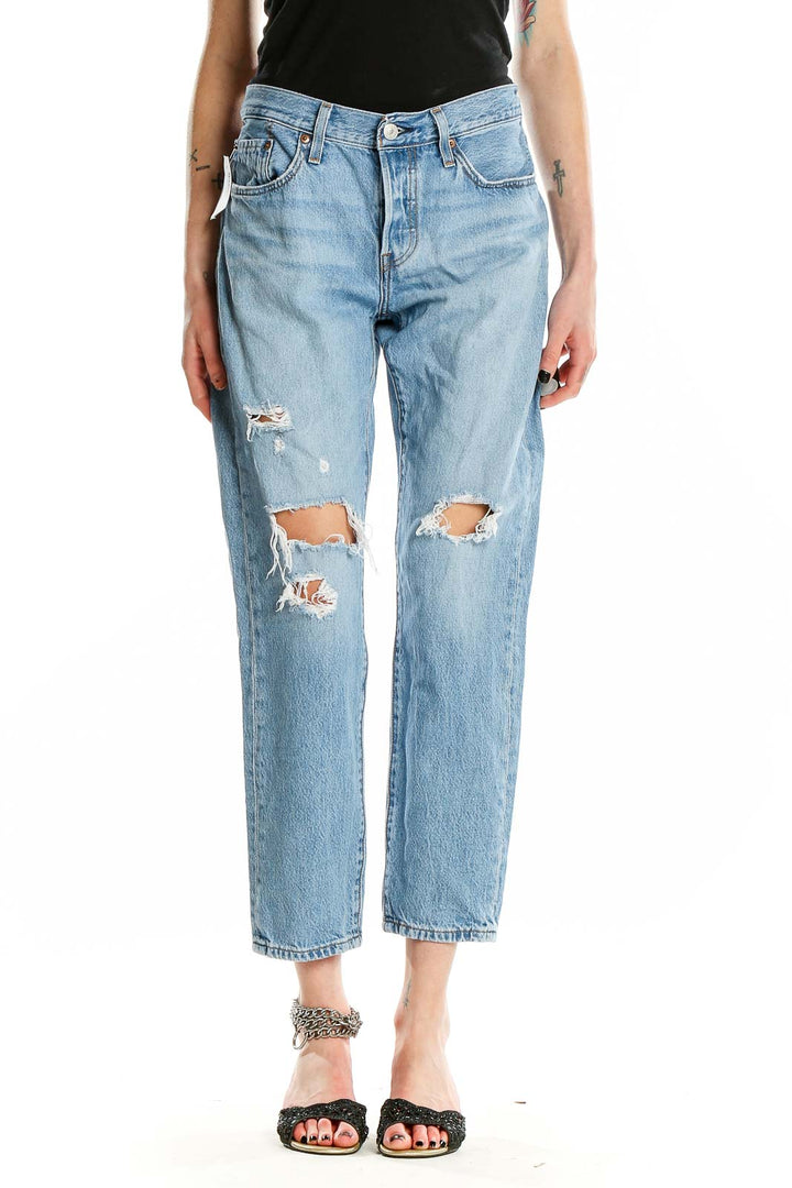 Front view of Levi's light blue distressed straight leg jeans on model