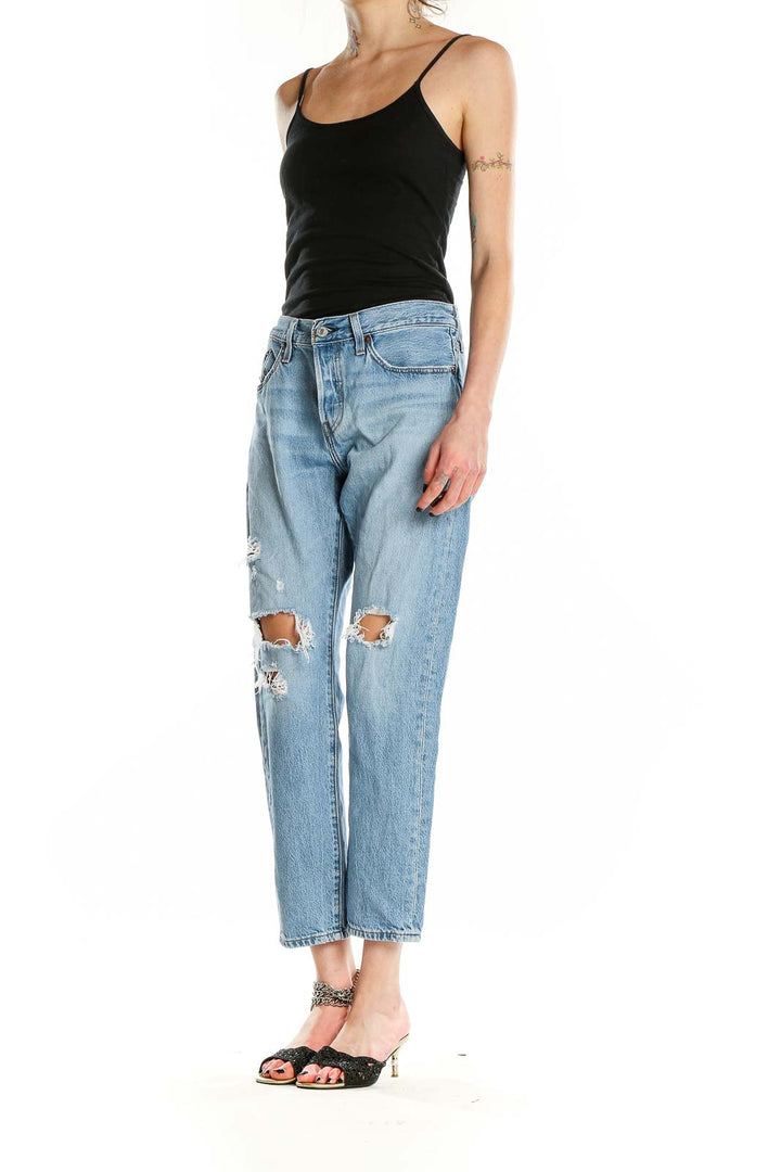 Front view of Levi's light blue distressed straight leg jeans on model