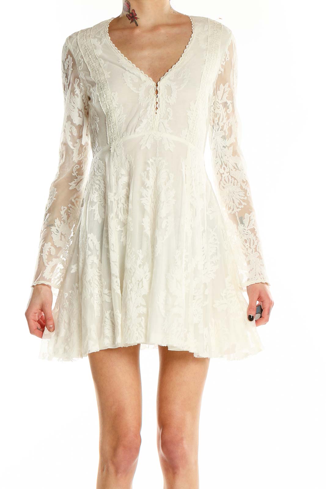 Front view of white lace mini dress with long sleeves and V-neckline