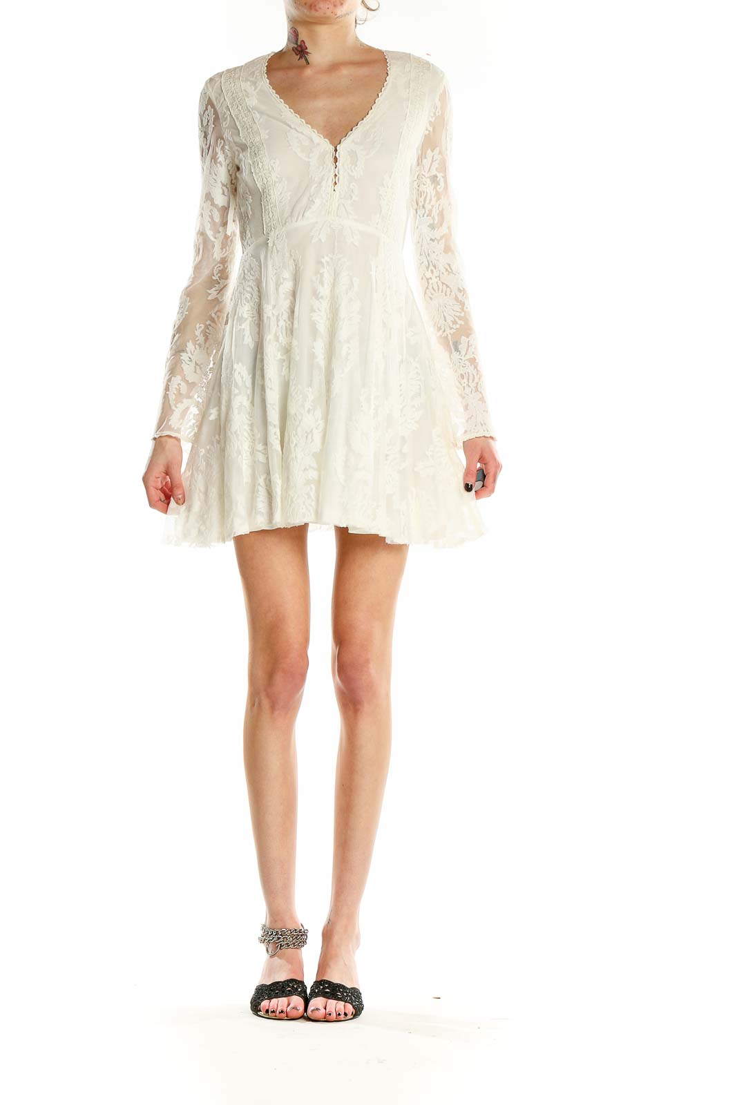 Front view of white lace mini dress with long sleeves and V-neckline