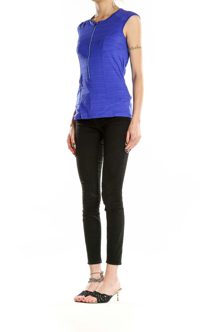 Front view of blue sleeveless Athleta athletic top with half-zip