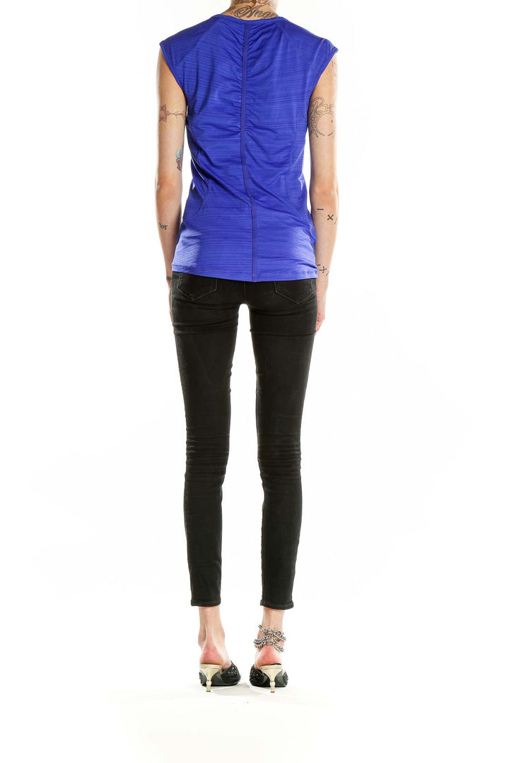 Back view of blue sleeveless Athleta athletic top showing form-fitting design