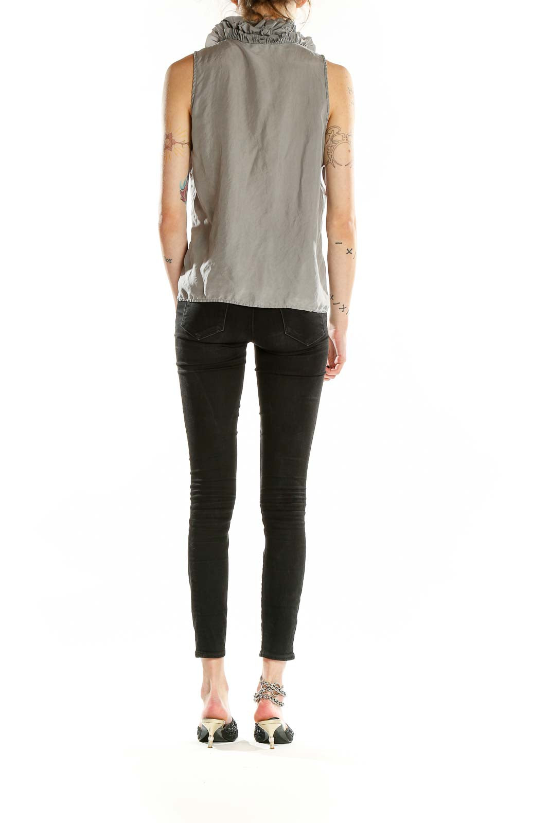 Back view of J.Crew gray silk sleeveless blouse on model with black pants