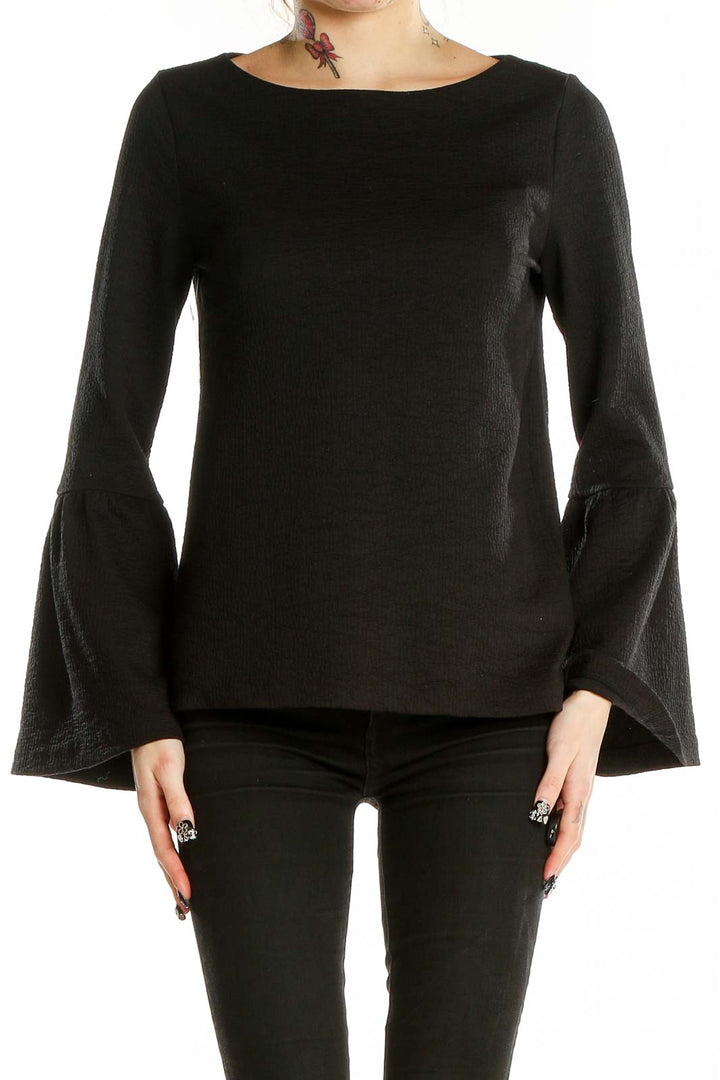 Front view of Ann Taylor black textured top with bell sleeves