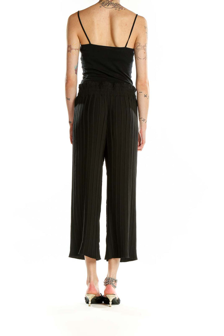 Back view of Rachel Zoe black pleated wide-leg cropped pants on model