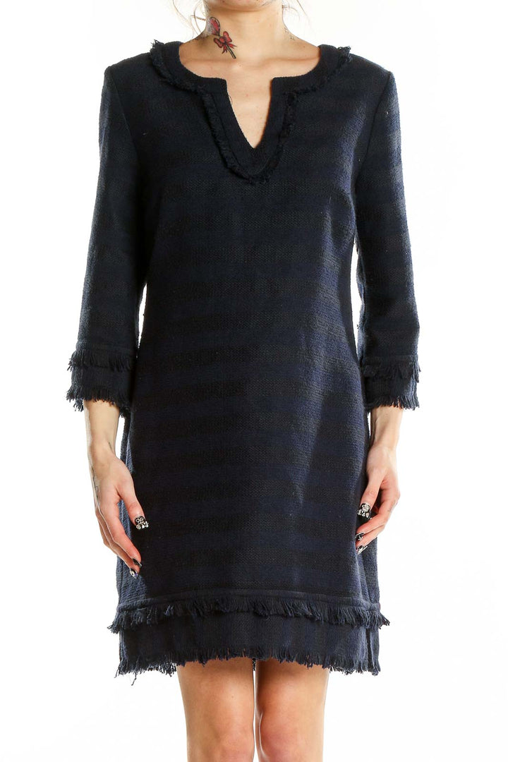 Front view of Trina Turk navy knit dress with fringe trim and V-neckline