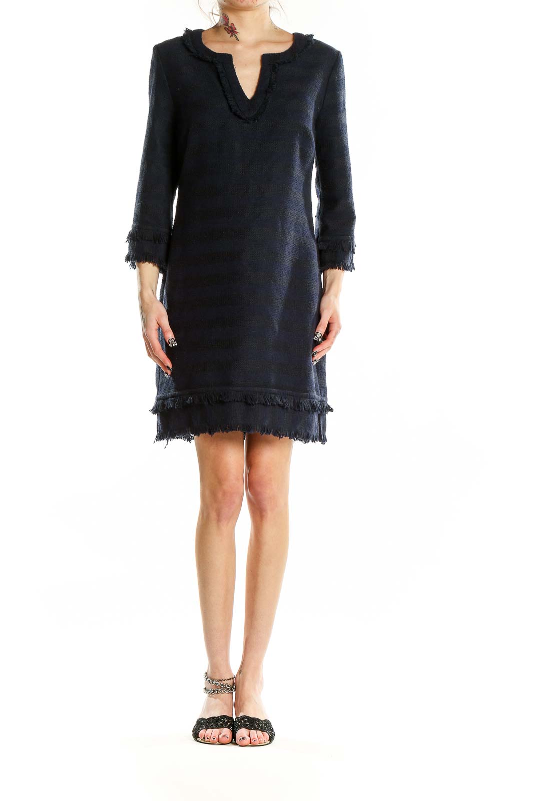 Front view of Trina Turk navy knit dress with fringe trim and V-neckline