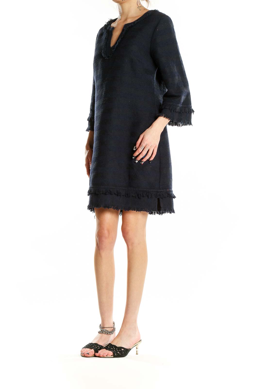 Front view of Trina Turk navy knit dress with fringe trim and V-neckline