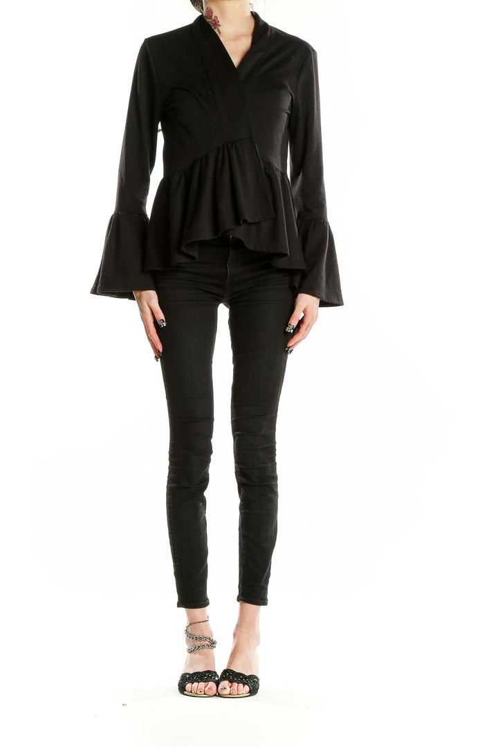 Front view of black peplum top with bell sleeves by Pebble and Stone