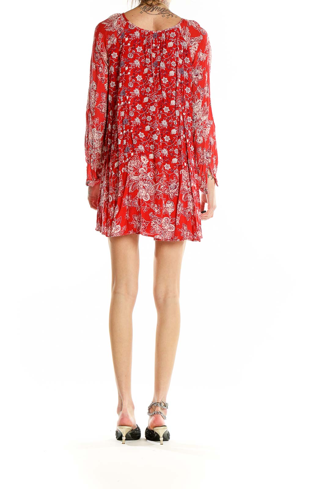 Back view of red floral Free People mini dress showing flowy silhouette