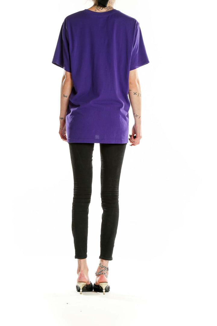 Back view of purple Nike activewear t-shirt showing relaxed fit