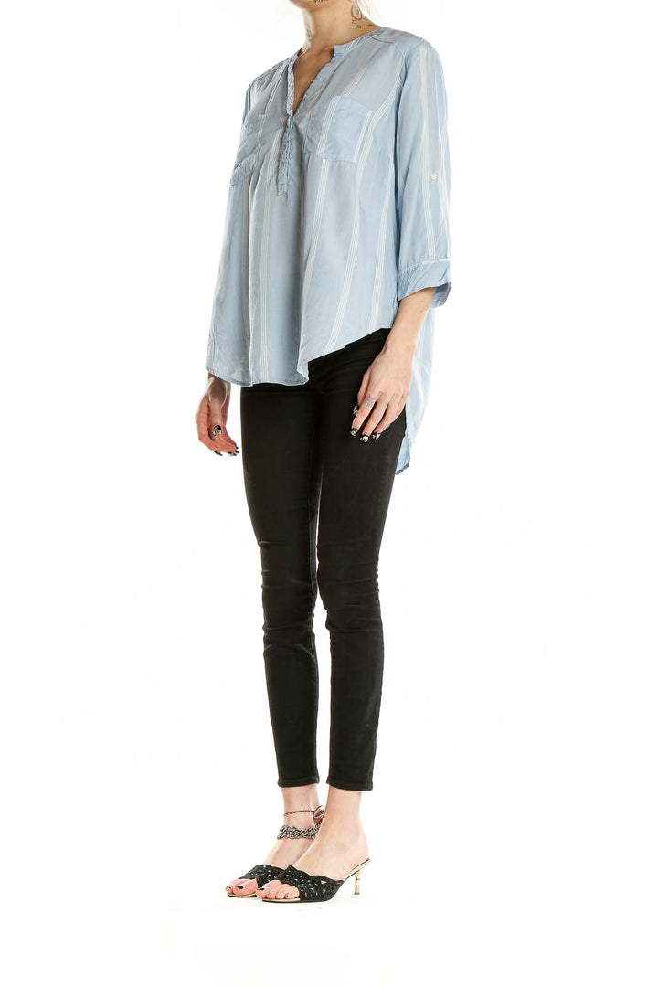 Front view of light blue striped modal blouse from Torrid with v-neck and patch pockets