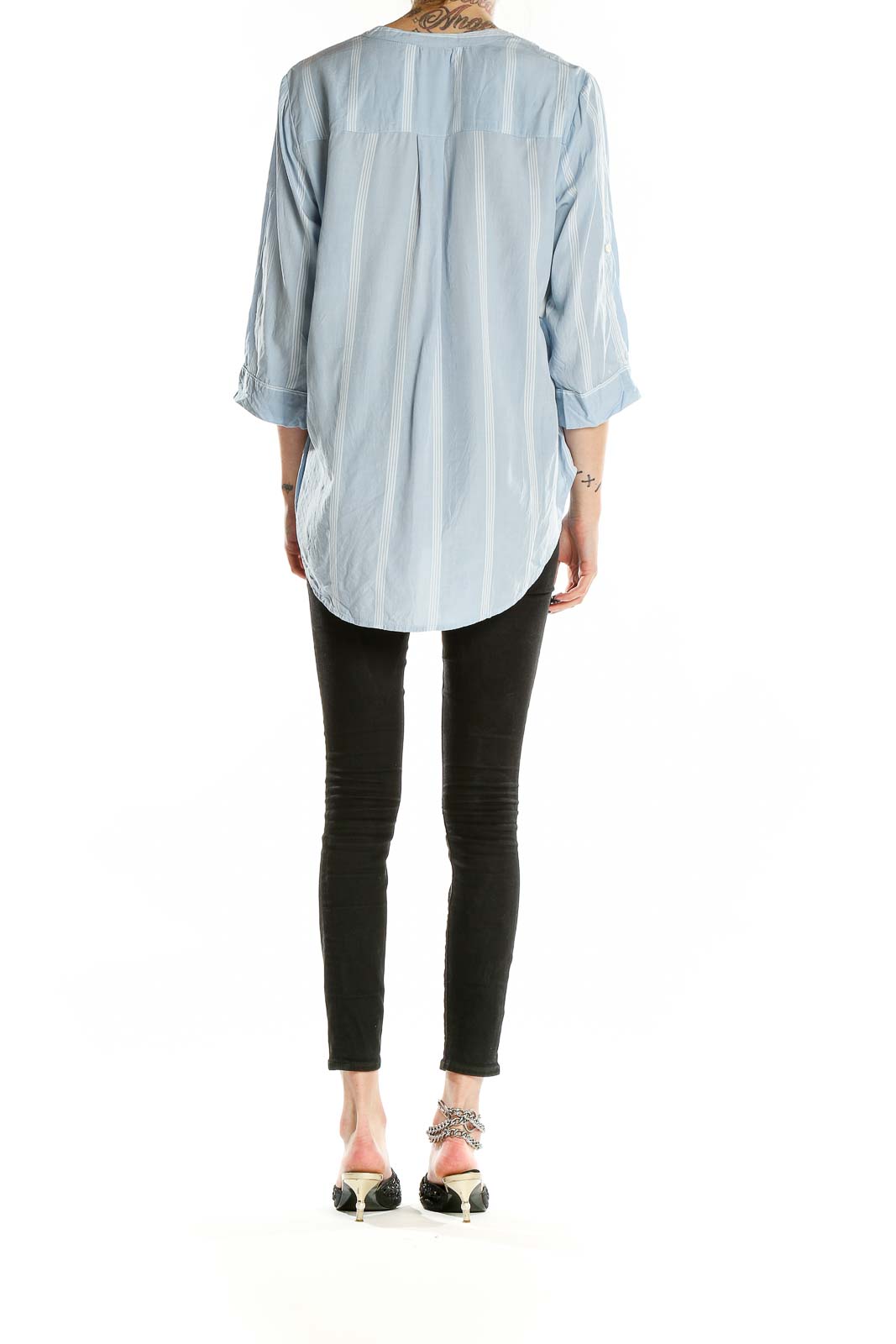 Back view of light blue striped modal blouse from Torrid showing high-low hemline