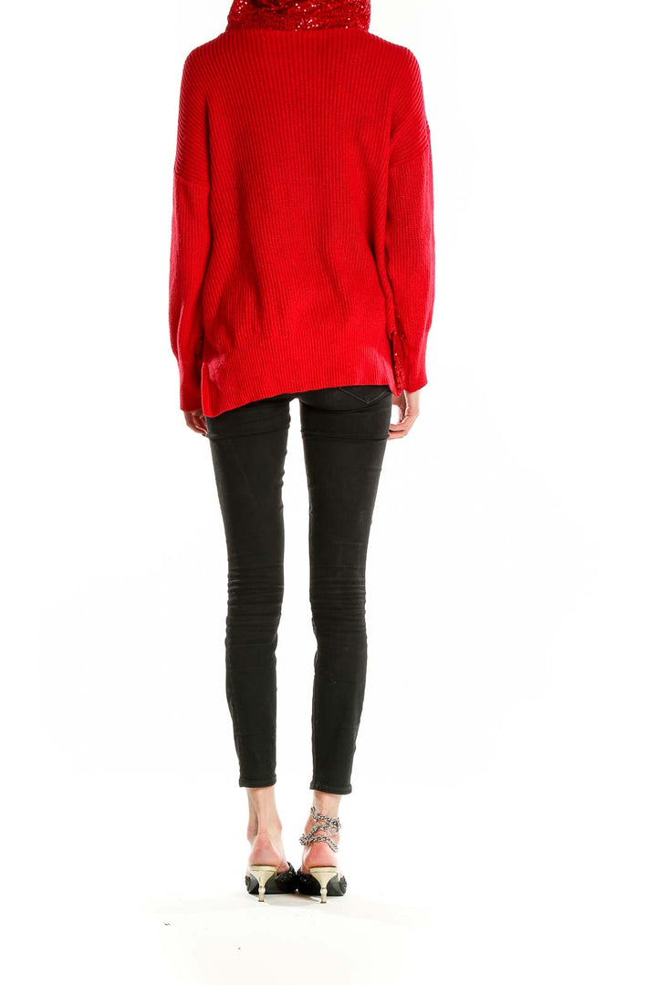 Back view of red hooded sweater showing ribbed texture and relaxed fit