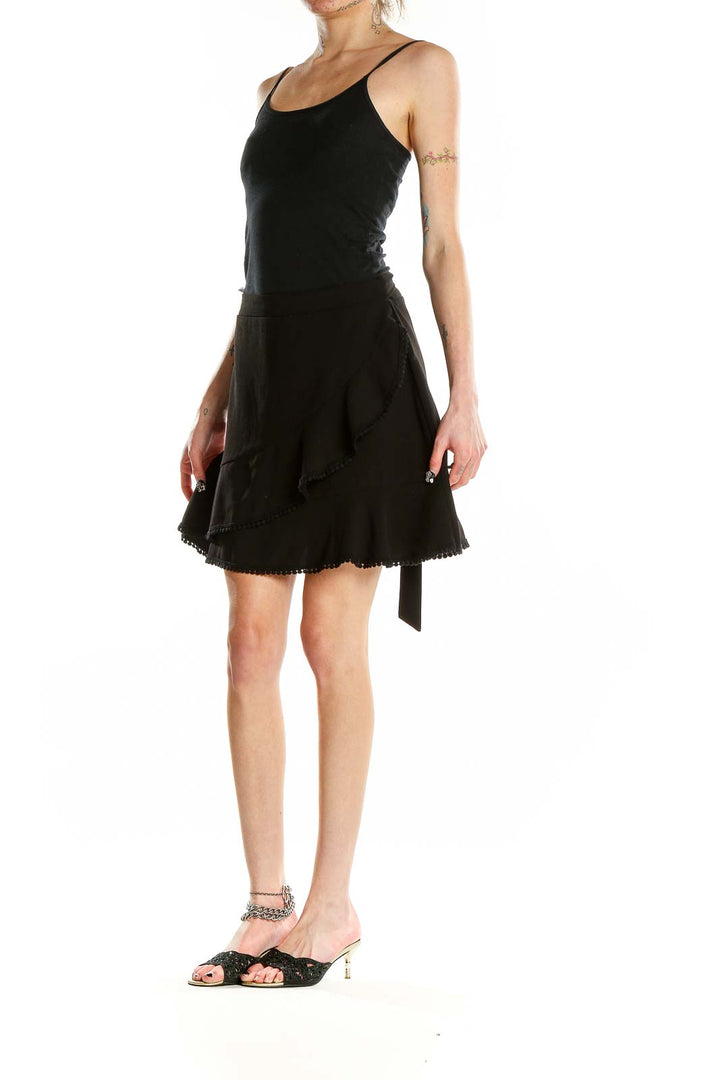 Front view of Cupcakes and Cashmere black ruffled mini skirt with asymmetrical design