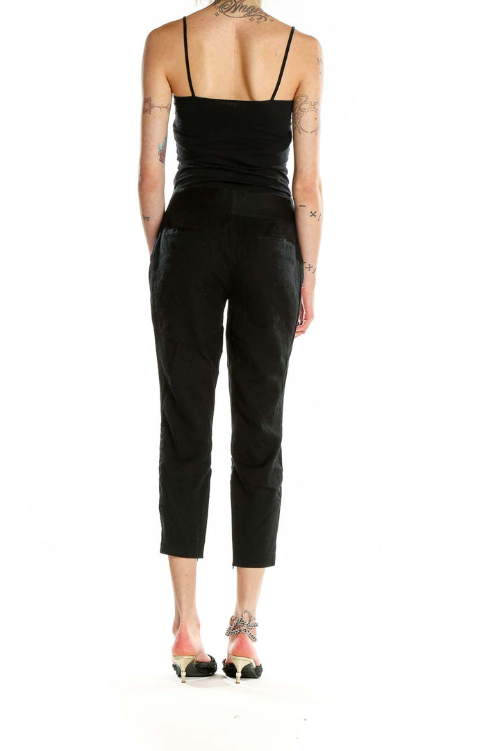 Back view of Alice + Olivia black cropped wool-blend trousers on model