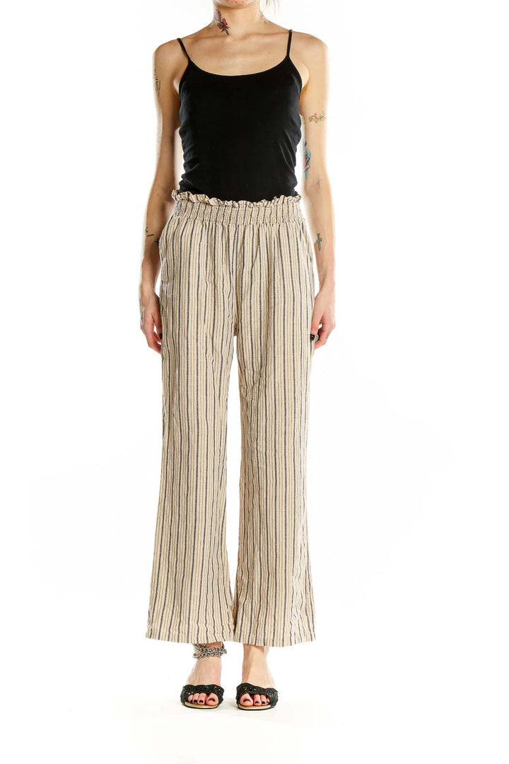 Front view of beige striped wide-leg cotton pants with paper bag waist