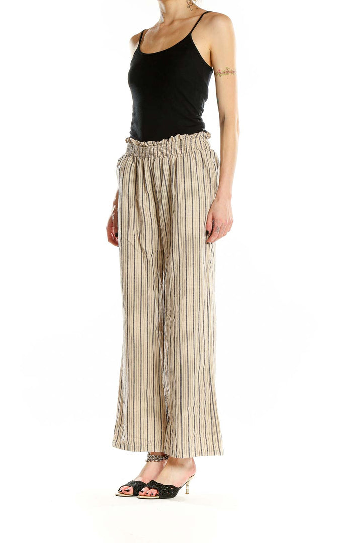 Front view of beige striped wide-leg cotton pants with paper bag waist