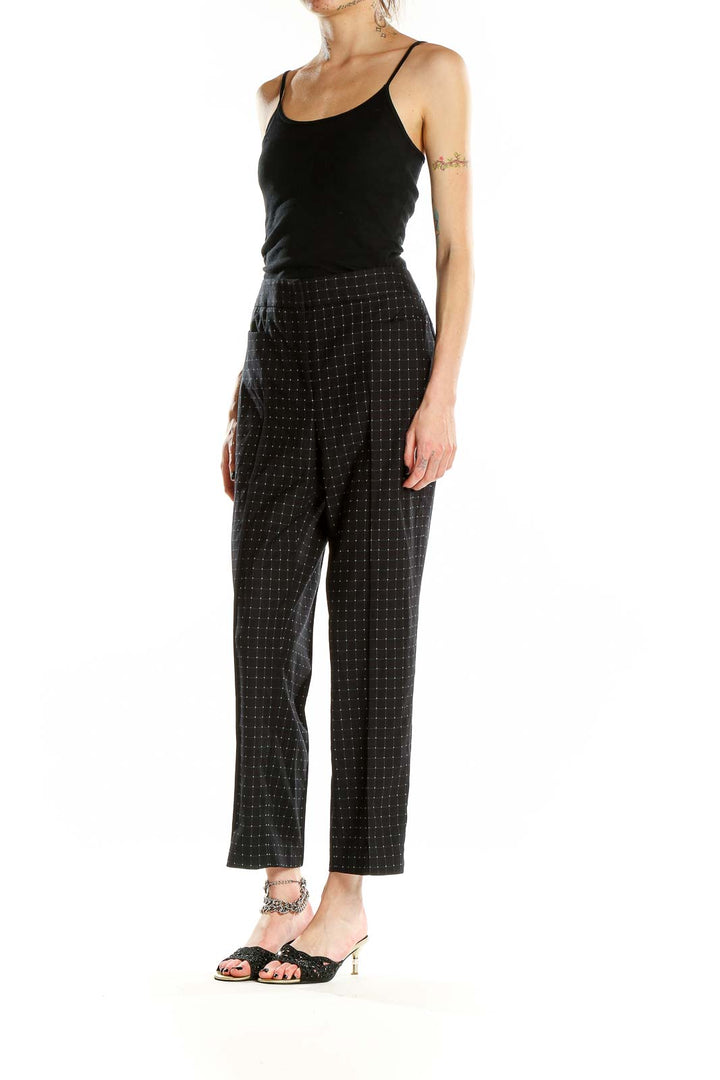 Front view of DKNY black high-waist pants with dotted pattern