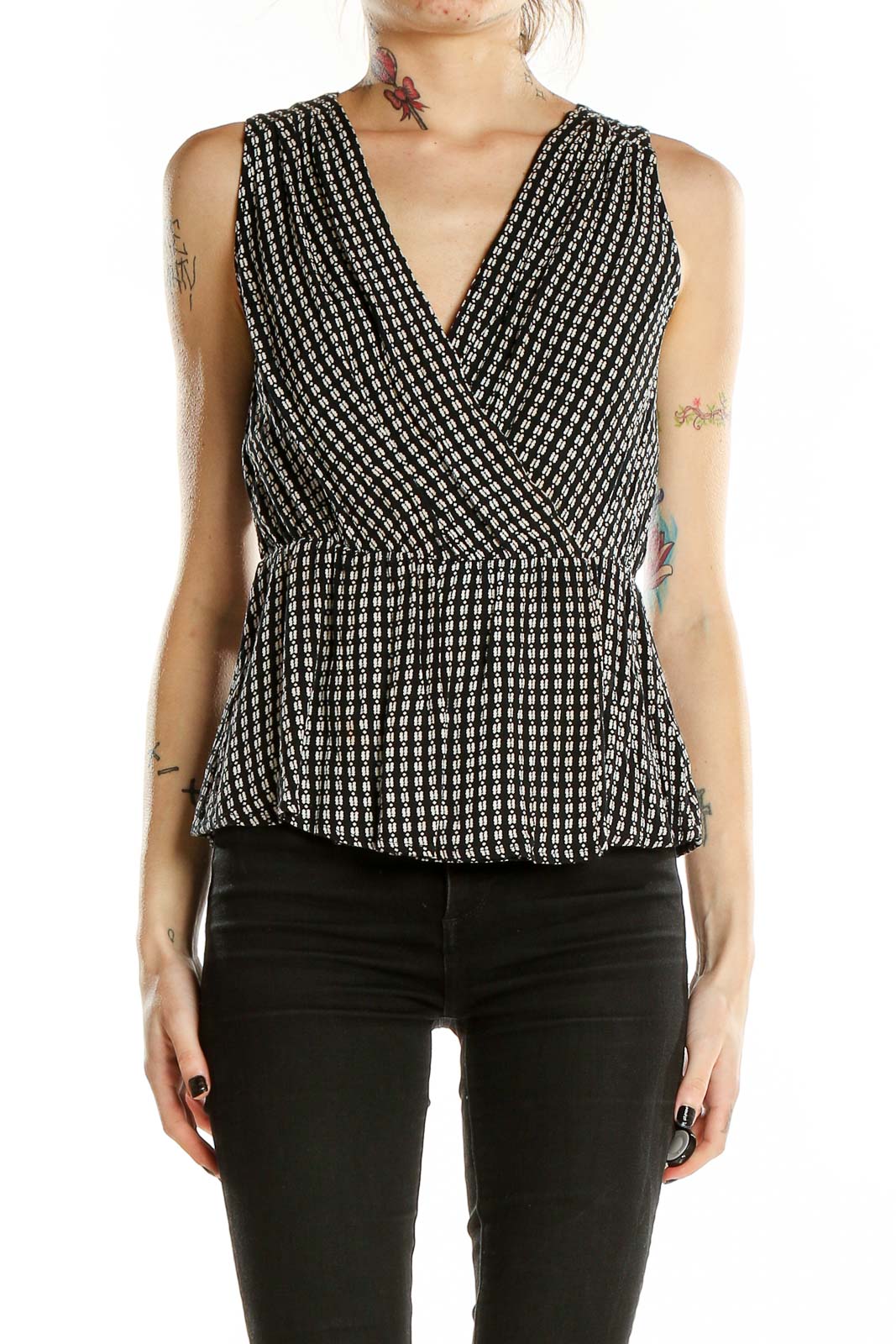 Front view of Chelsea28 black and white geometric print peplum top with V-neck