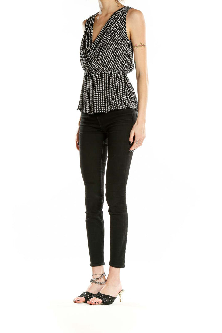 Front view of Chelsea28 black and white geometric print peplum top with V-neck