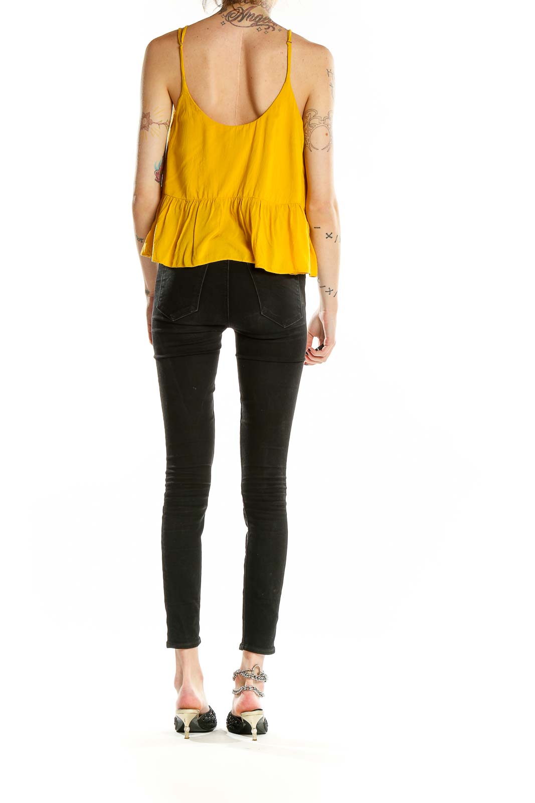 Back view of yellow Topshop camisole top showing thin straps and flowy design