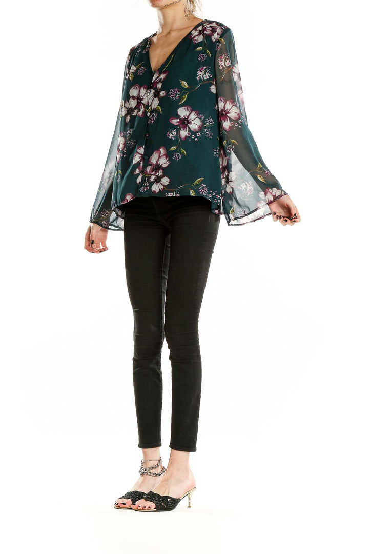 Front view of Cupcakes and Cashmere green floral blouse with V-neckline