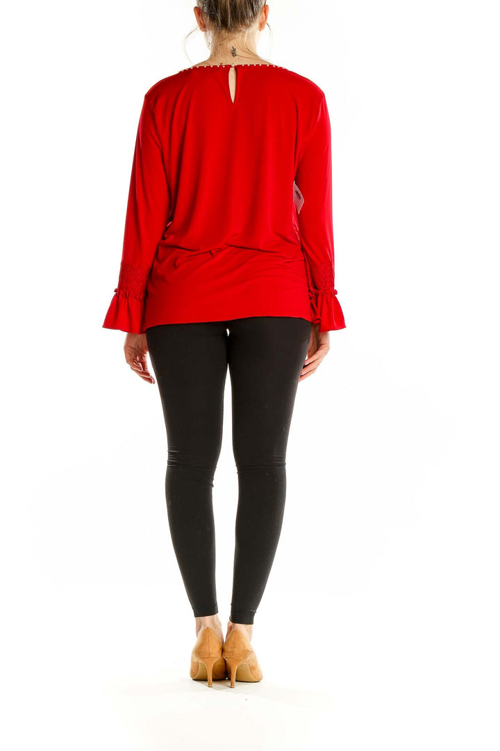 Back view of Karl Lagerfeld red top showing keyhole detail and bell sleeves