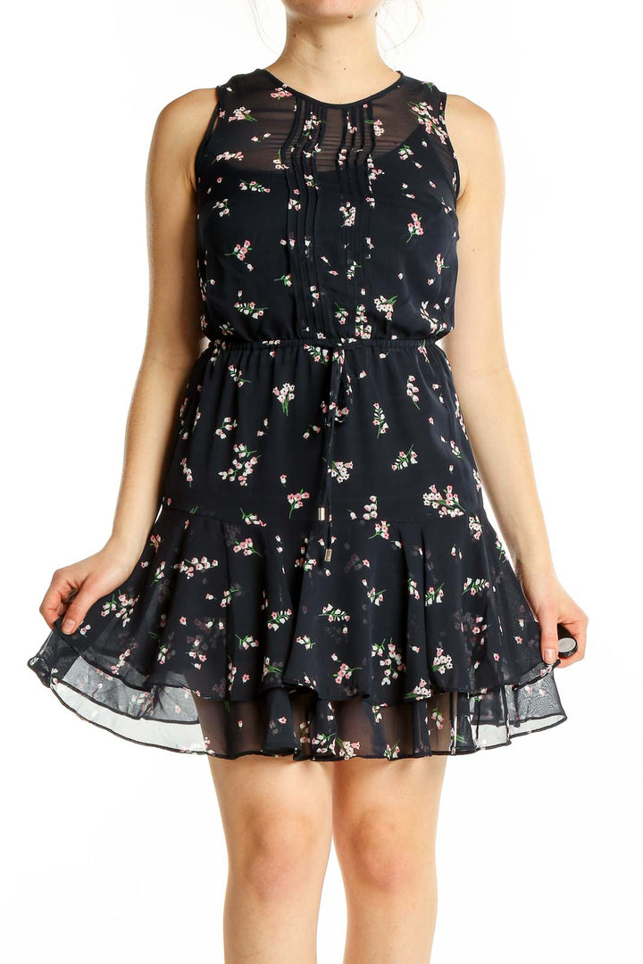 Front view of Tommy Hilfiger black floral sleeveless mini dress with ruffle skirt