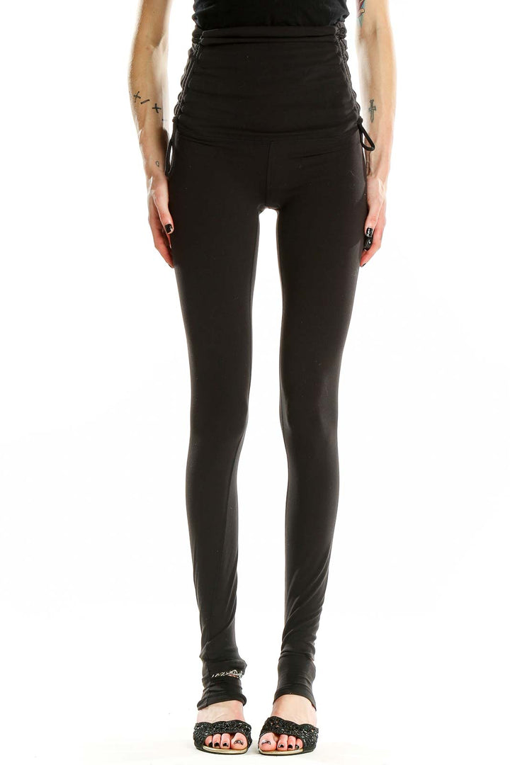 Front view of black Lululemon high-waisted yoga leggings with ruched sides