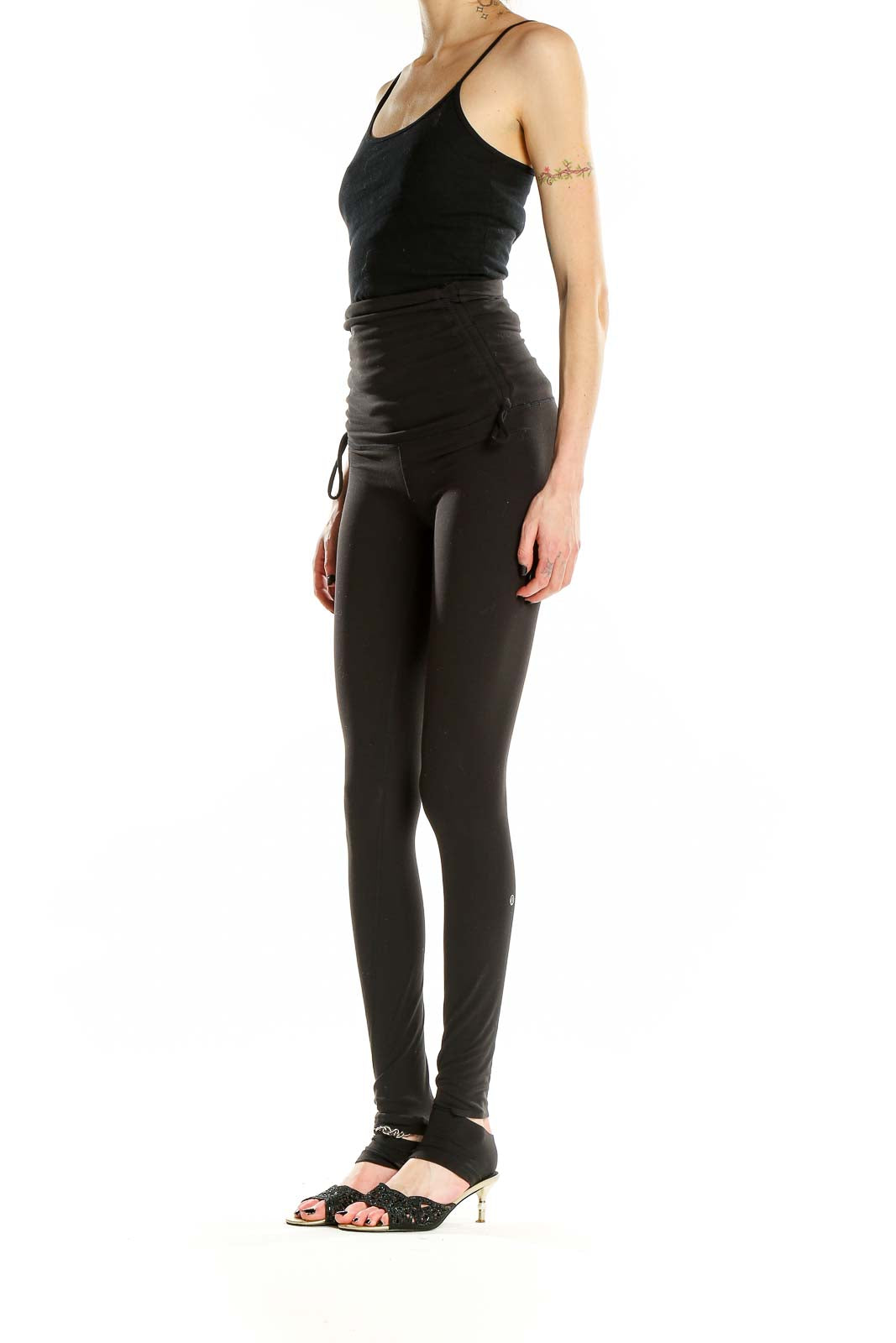 Front view of black Lululemon high-waisted yoga leggings with ruched sides