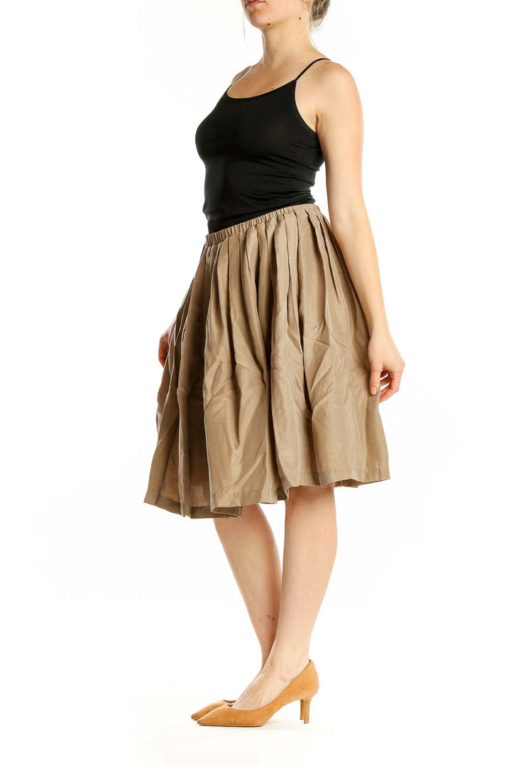 Front view of Pell & Co. beige silk pleated midi skirt on model