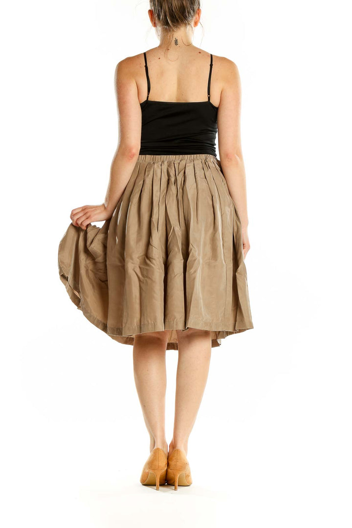 Back view of Pell & Co. beige silk pleated midi skirt on model