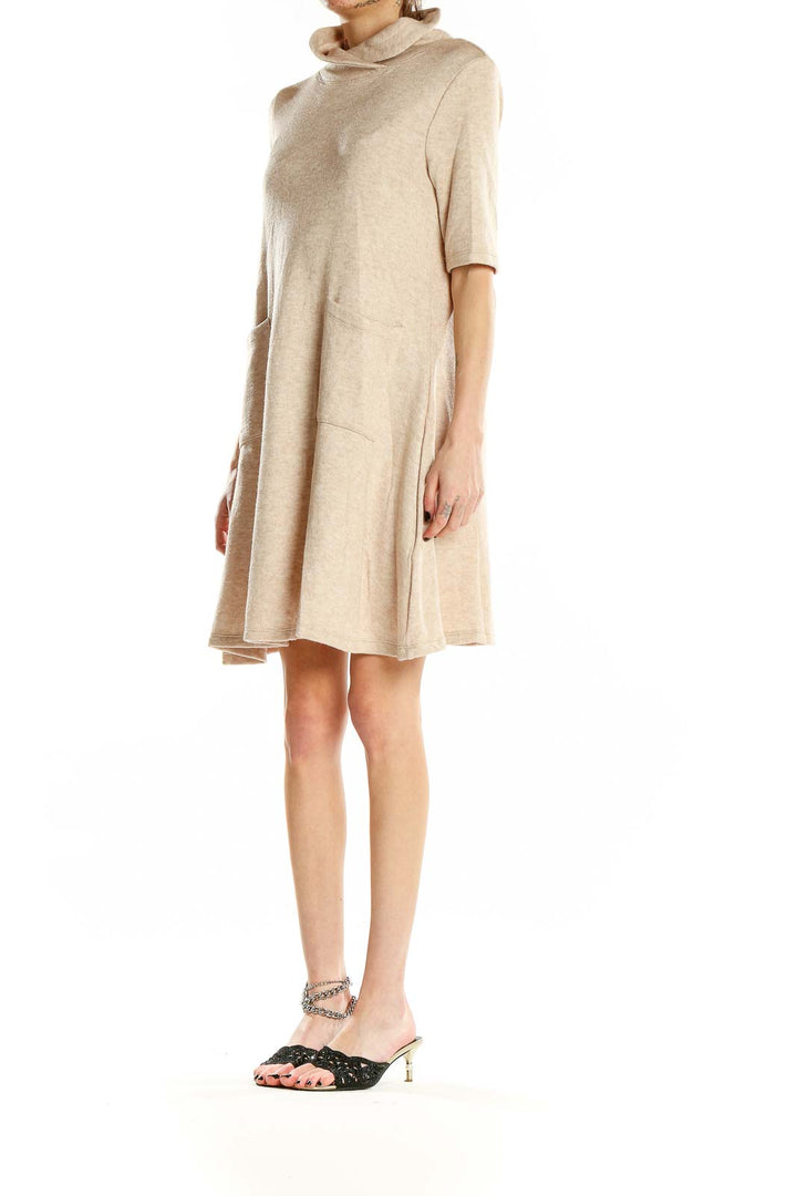 Front view of beige turtleneck swing dress with pockets