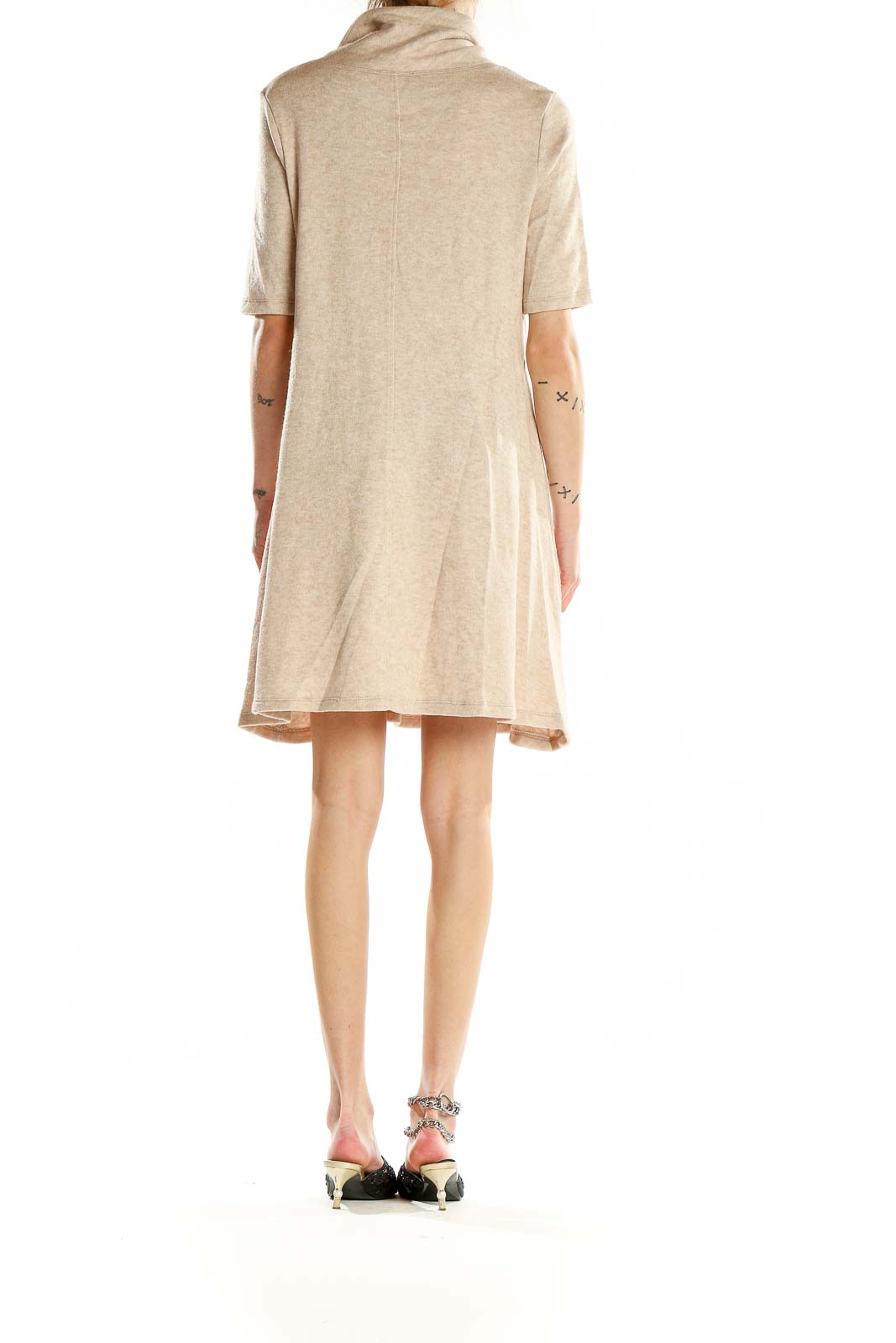 Back view of beige turtleneck swing dress showing A-line silhouette