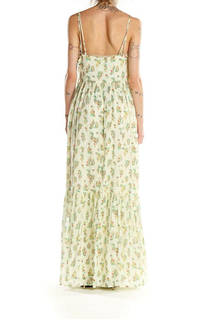 Back view of ModCloth yellow floral maxi dress showing tiered skirt and open back design