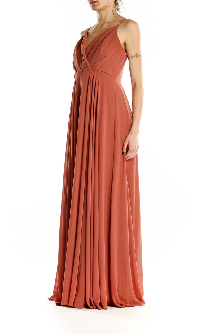 Front view of terracotta pleated maxi dress with V-neckline and spaghetti straps